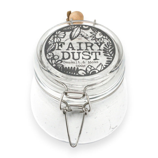 Clear jar labeled 'Fairy Dust' with decorative lid on a white background