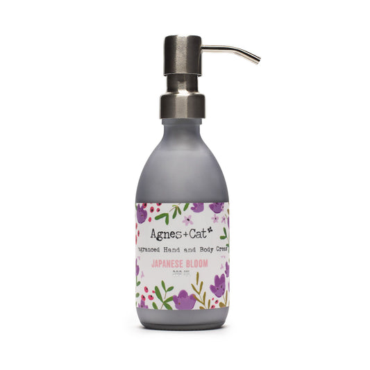 Hand cream bottle with floral label on a white background