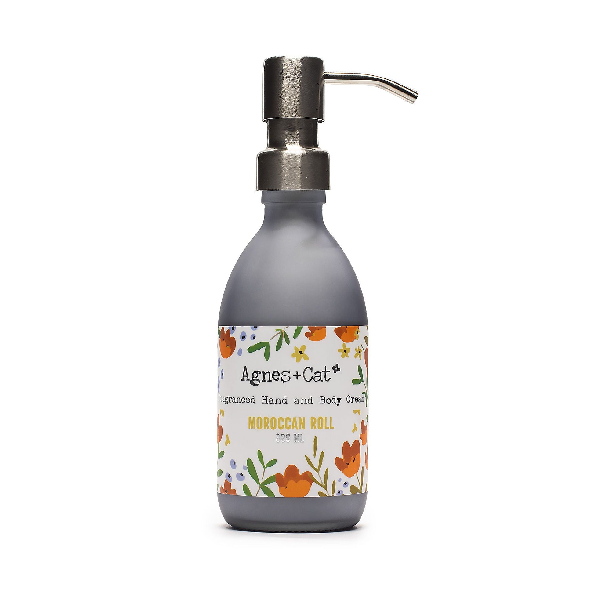 Hand cream bottle with pump and floral label on a white background