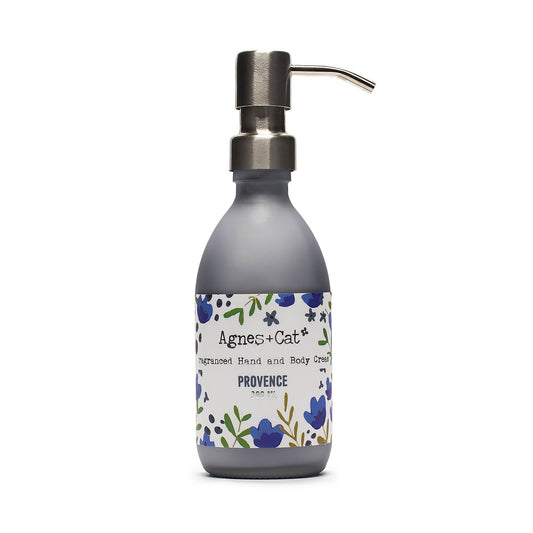 Hand cream bottle with floral label on a white background