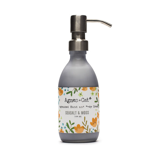 Hand cream bottle with floral label on a white background