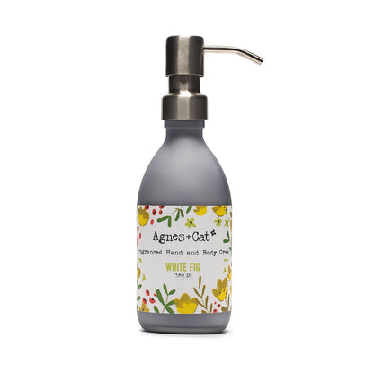 Hand and body cream bottle with floral label on a white background