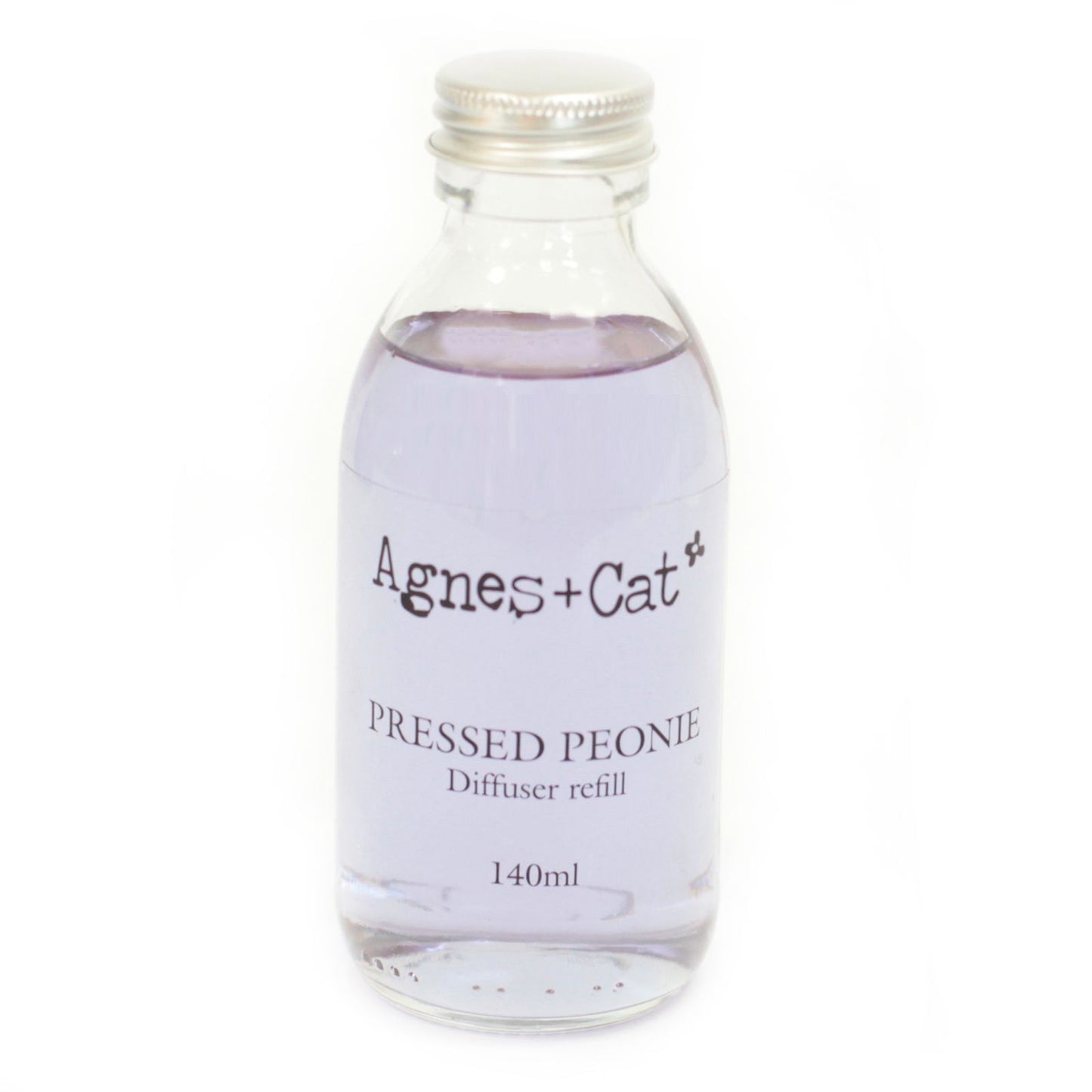 Glass diffuser refill bottle labeled 'Agnes + Cat Pressed Peony' on a white background
