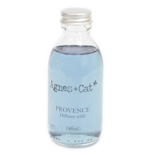Glass diffuser refill bottle with silver cap labeled 'Agnes + Cat Provence' on a white background