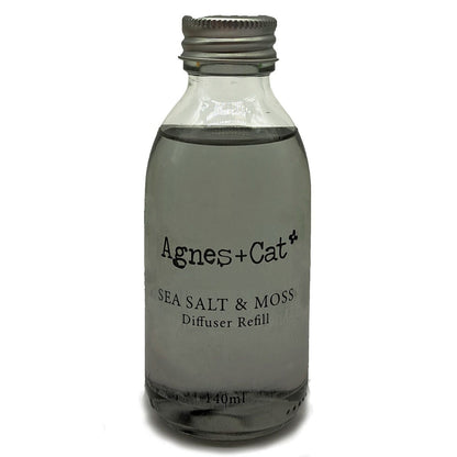 Glass diffuser refill bottle labeled 'Agnes + Cat Sea Salt & Moss' on a white background