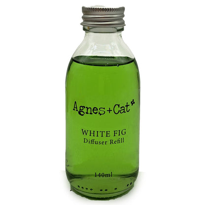 Green bottle of Agnes + Cat White Fig diffuser refill on a white background