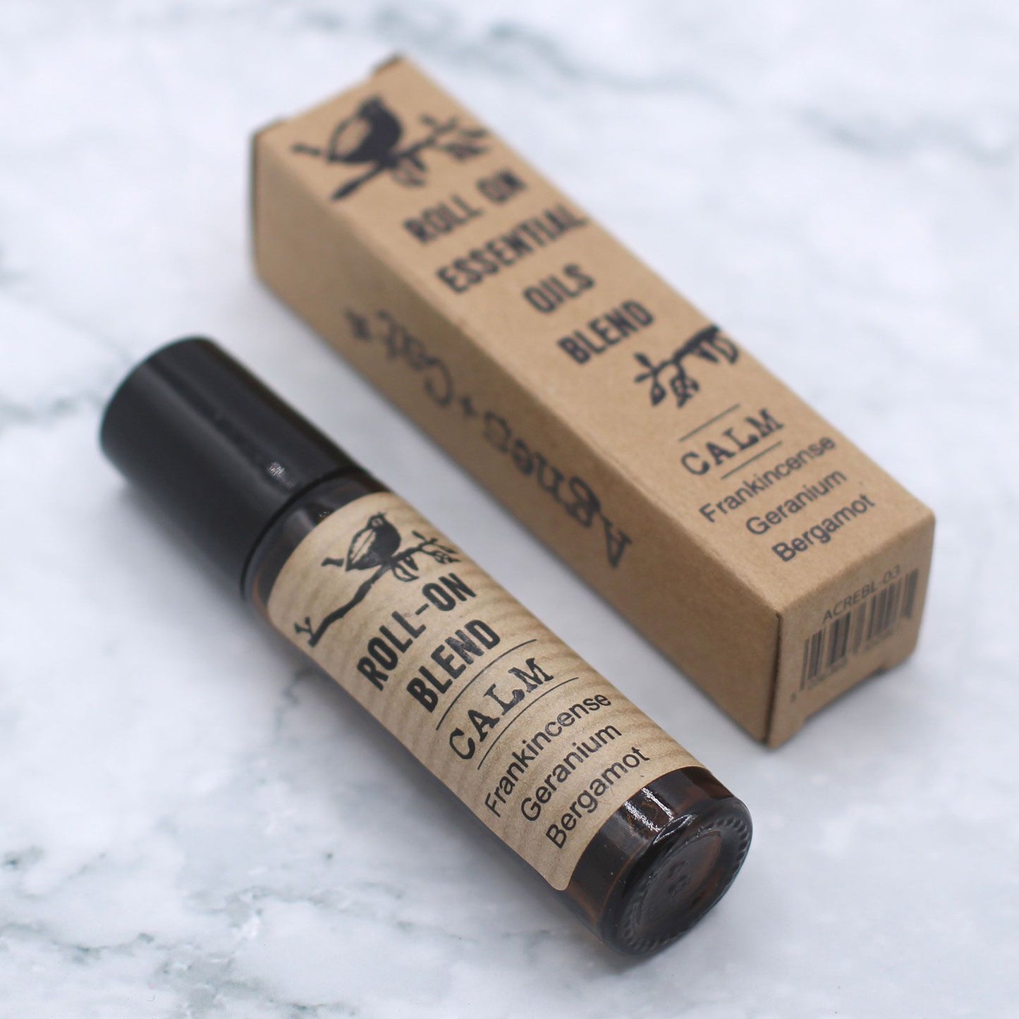 Roll-on blend bottle and box on a marble surface
