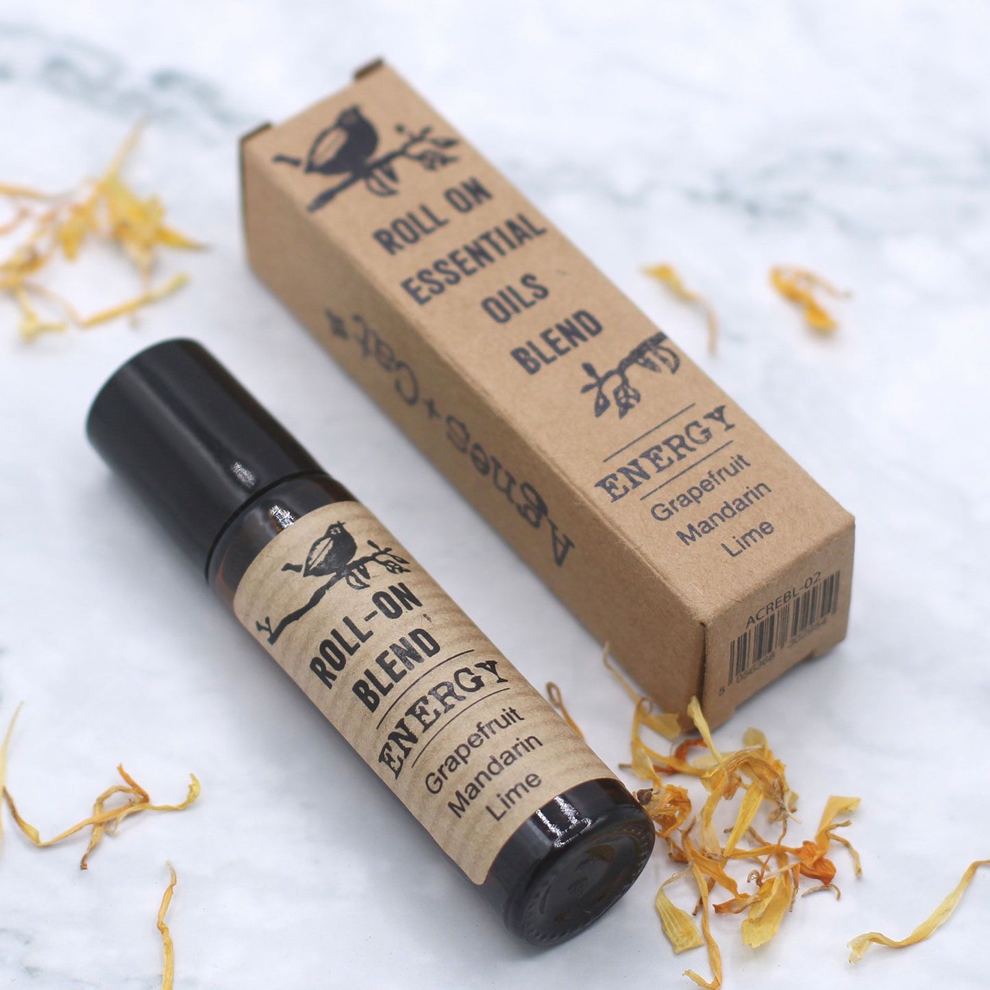 Roll-on essential oils blend with packaging on a light background