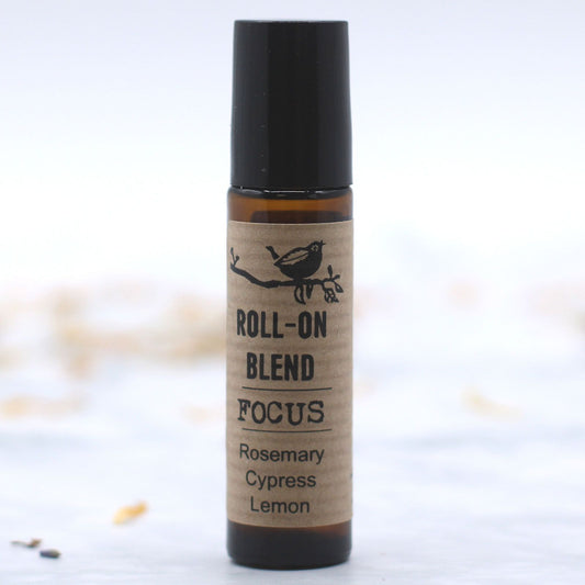 Roll-on blend labeled 'Focus' with ingredients on a white background