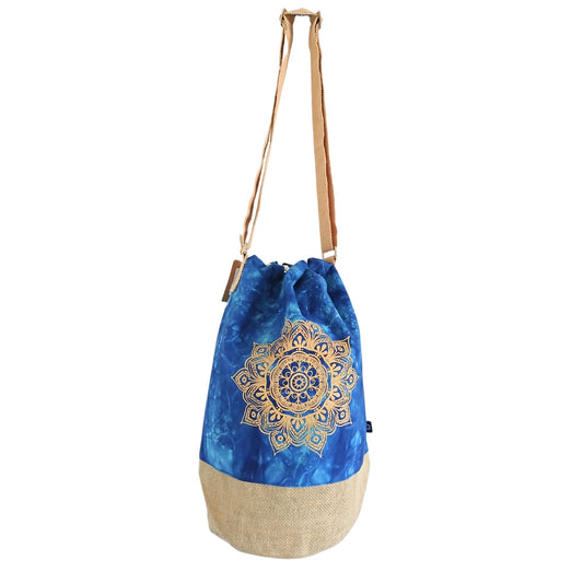 Blue drawstring bag with mandala design and beige bottom on a white background