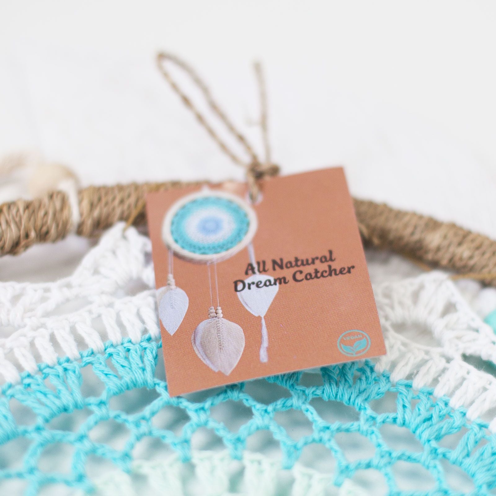 All Natural Dream Catcher with a card on a textured surface