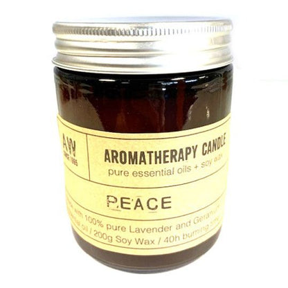 Aromatherapy candle labeled 'Peace' with a metal lid on a white background