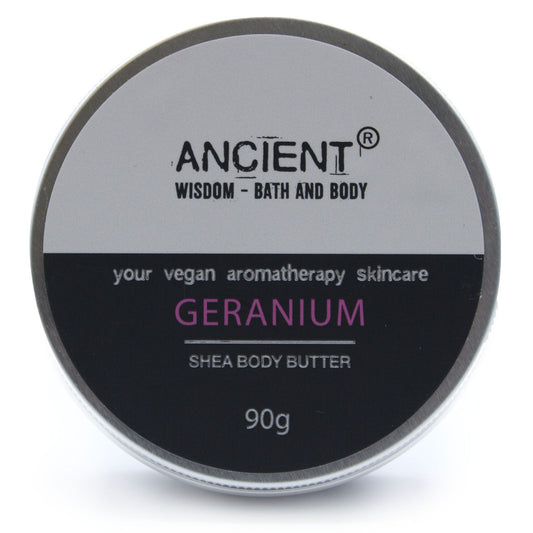 Shea body butter container labeled 'Ancient Wisdom Bath and Body' with 'Geranium' scent on a white background.