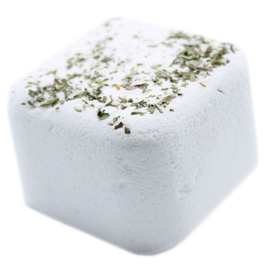 Square block of white salt with green herbs on a white background