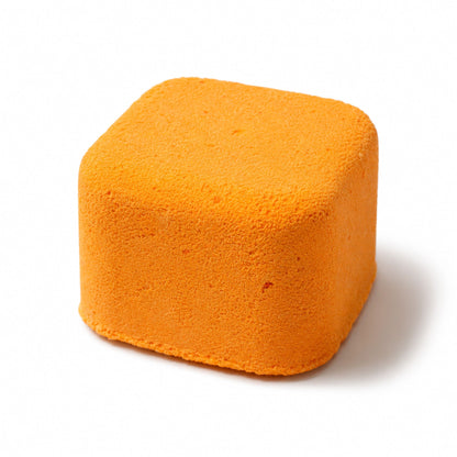 Orange cube-shaped sponge on a white background