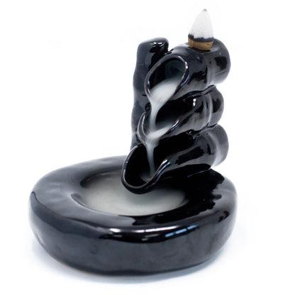 Black incense burner with smoke on a white background
