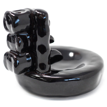 Black ceramic bear-shaped object on a white background