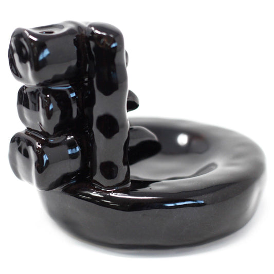 Black ceramic bear-shaped object on a white background