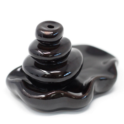 Black ceramic incense burner on a white background