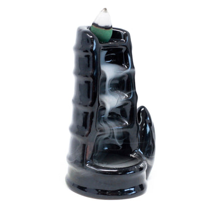 Black incense burner with smoke on a white background