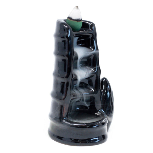 Black incense burner with smoke on a white background