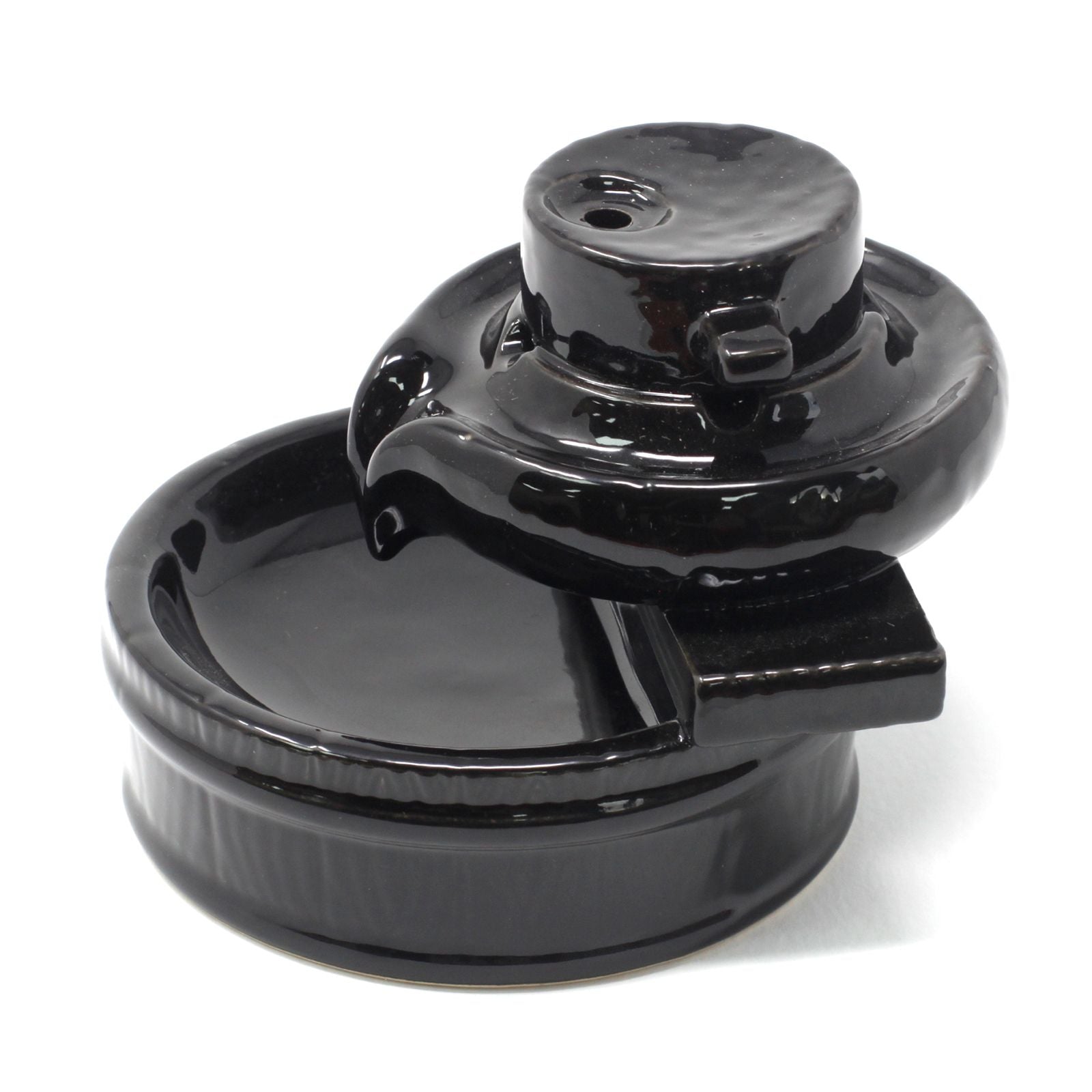 Black ceramic backflow burner on a white background