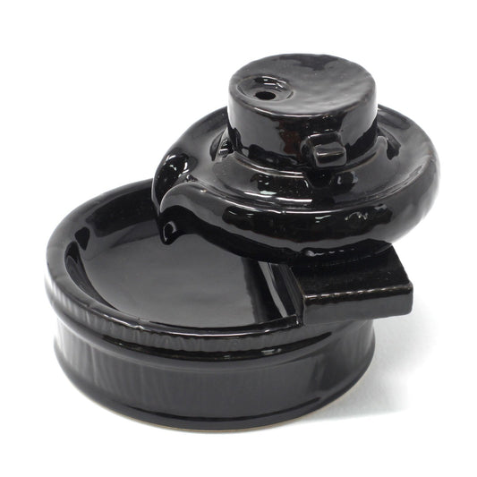 Black ceramic backflow burner on a white background