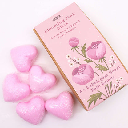 Pink heart-shaped bath bombs with a box labeled 'Blooming Pink Bliss' on a white background