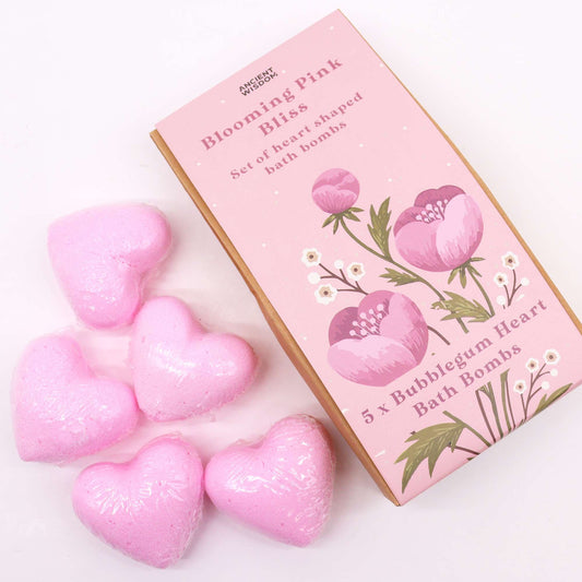 Pink heart-shaped bath bombs with a box labeled 'Blooming Pink Bliss' on a white background