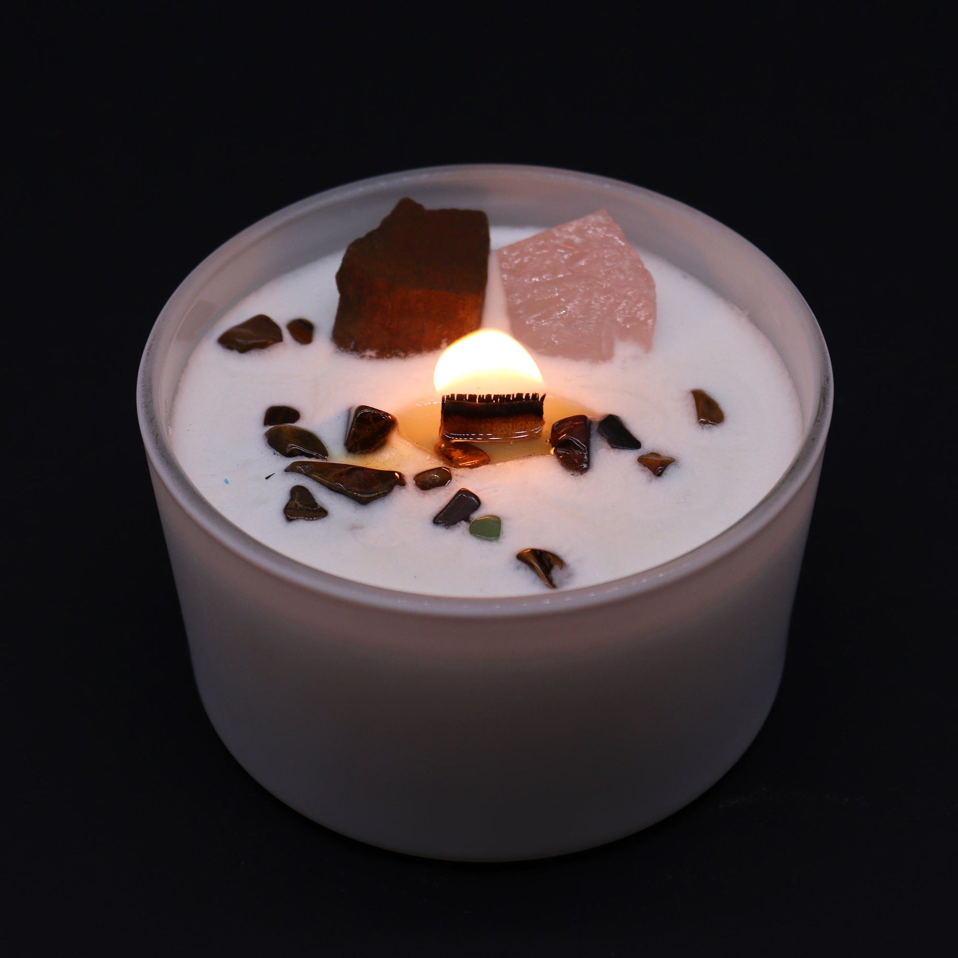 Unlock the power of your Sacred Sacral Chakra with this enchanting soy wax crystal candle. Embedded with Tiger Eye and Rose Quartz crystals, gemstones lit