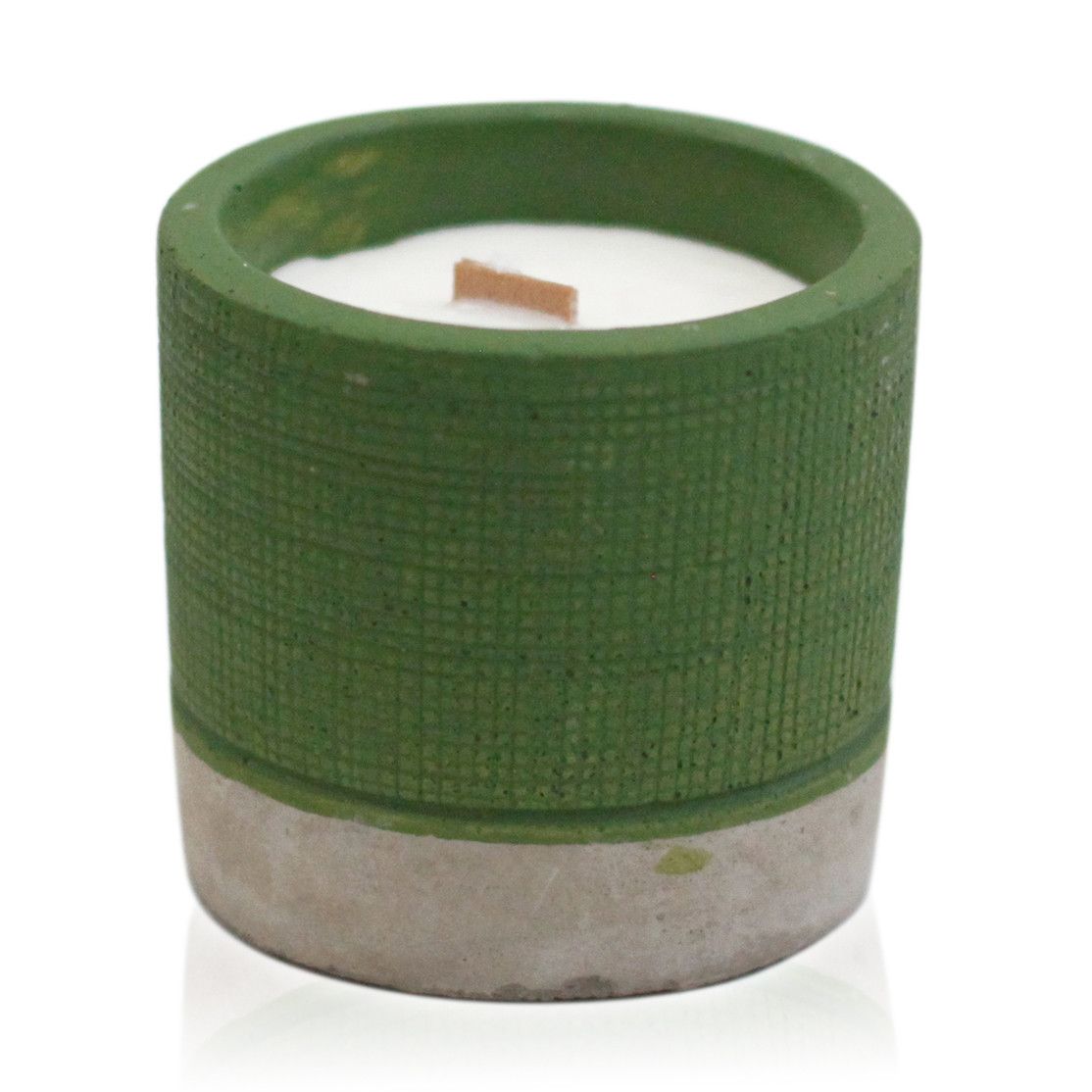 Green textured candle holder with a white candle inside on a white background