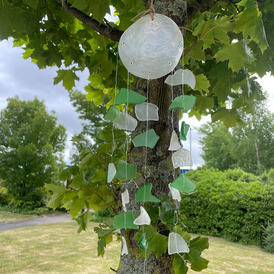 Bring harmony and a touch of nature to your outdoor space with a Recycled Glass Wind Chime Green &amp; White Glass. 