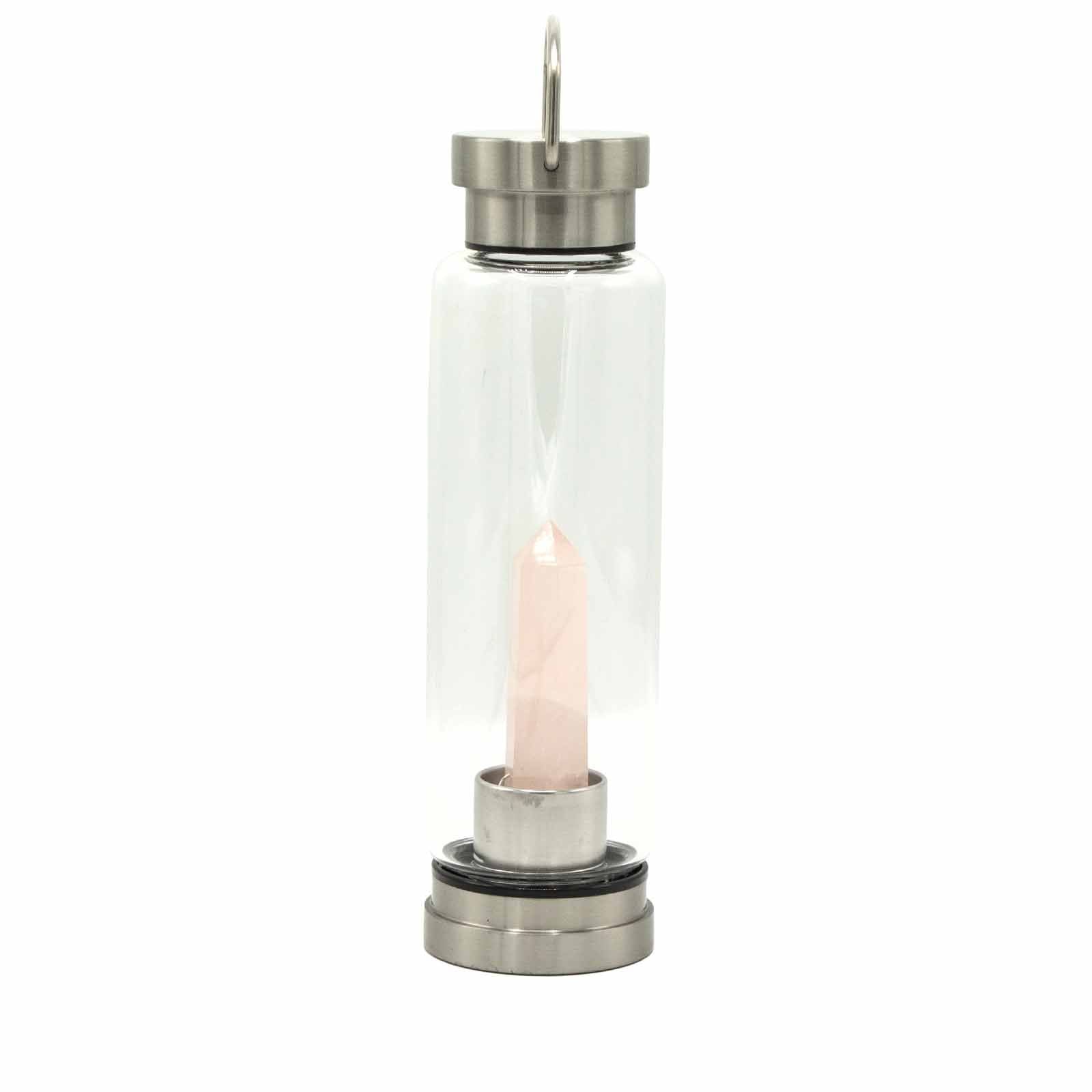 Clear glass lantern with a pink candle inside on a white background