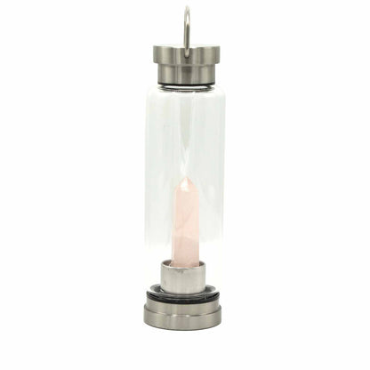 Clear glass lantern with a pink candle inside on a white background