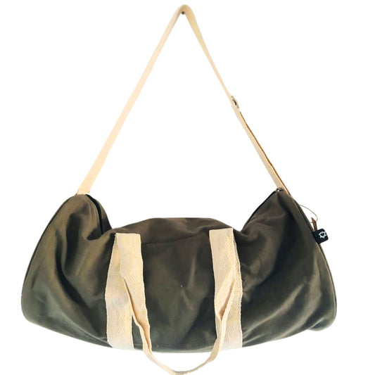 Green duffel bag with beige handles on a white background