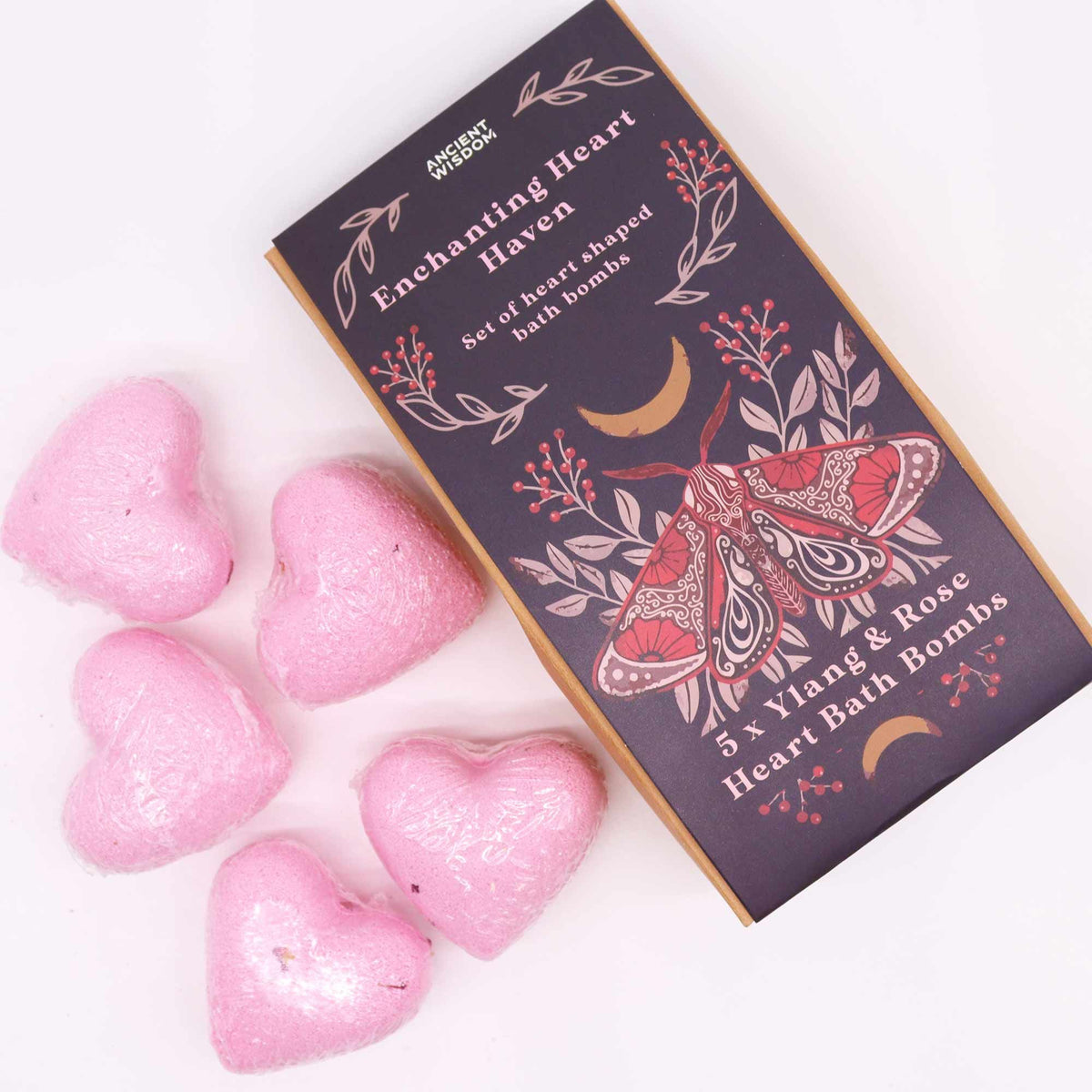 Pink heart-shaped bath bombs with a decorative box on a white background