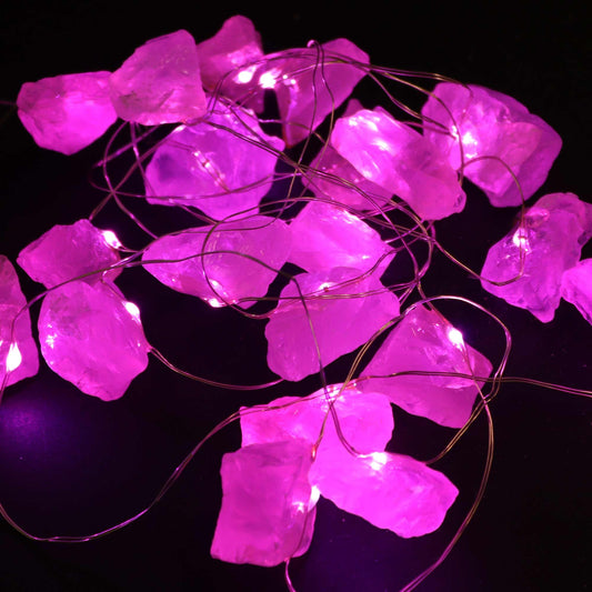 String of pink LED lights on a black background