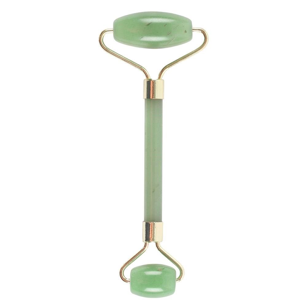 Green jade roller with gold accents on a white background