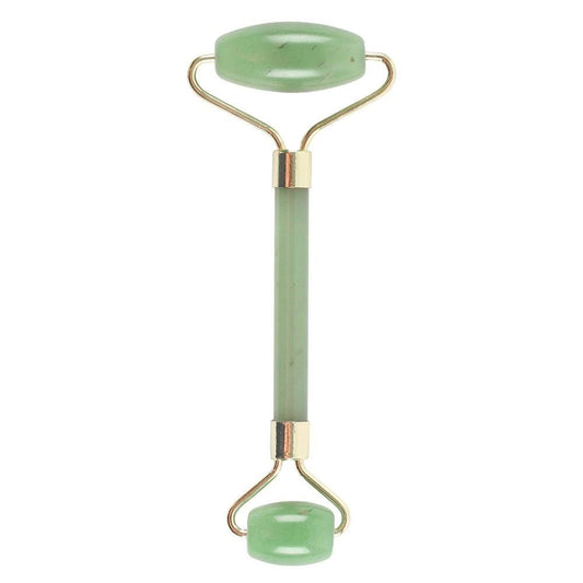 Green jade roller with gold accents on a white background