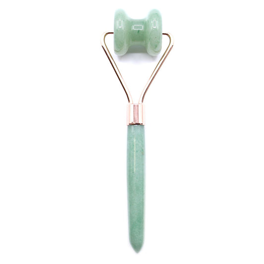 Green jade roller with rose gold accents on a white background