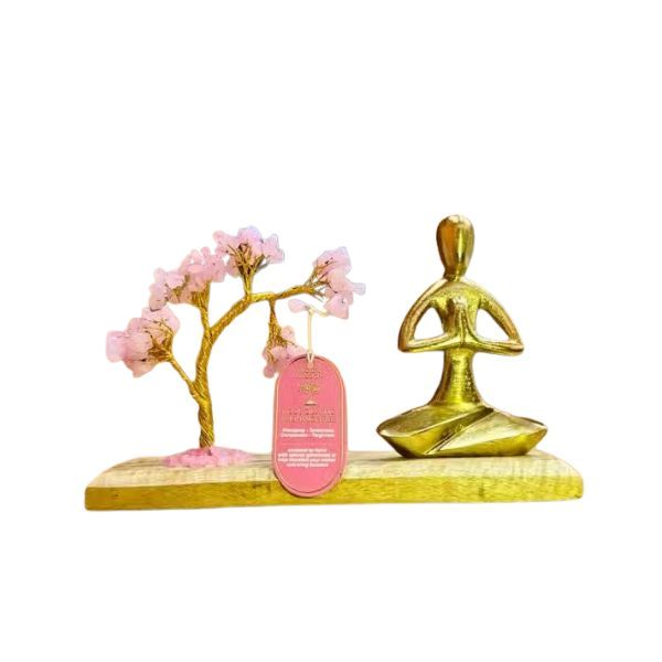 Decorative item with gold yoga figure and cherry blossom branch on a white background