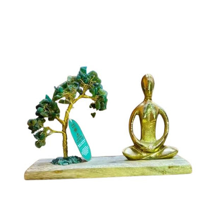 Decorative piece with a tree and a meditating figure on a white background