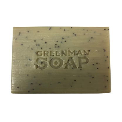 Bar of Greenman Soap with specks on a white background