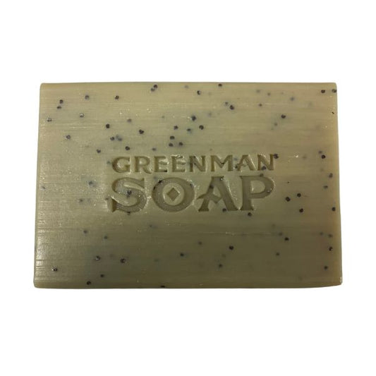 Bar of Greenman Soap with specks on a white background