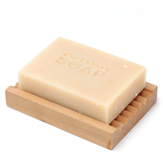 Bar of soap on a wooden soap dish with 'Crown Soap' branding.