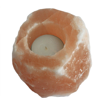 Himalayan salt lamp with a candle inside on a white background