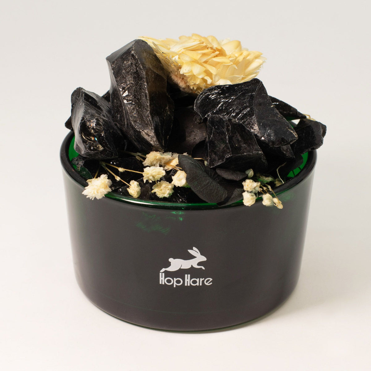 Black container with crystals and flowers on a white background, featuring the 'lop hare' brand.