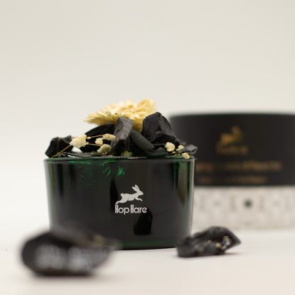 Black container with decorative elements and a visible brand logo on a light background