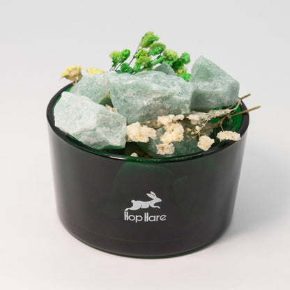 Black container with green crystals and flowers on a white background, featuring the 'Hooplaire' brand.