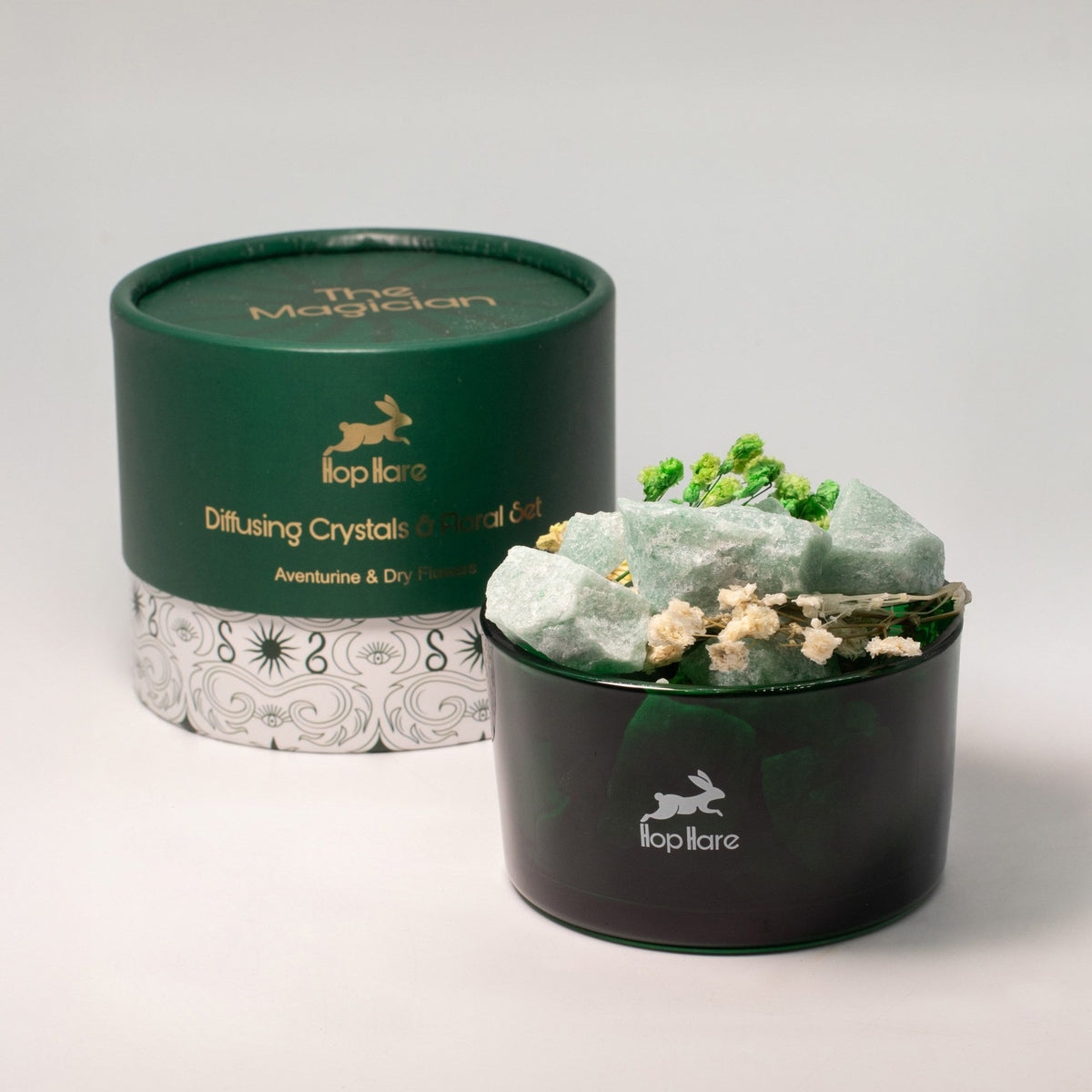 Diffusing crystals in a black container with 'The Magician' branding on a gray background